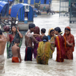 Flood victims bathe in flood water near a shelter in Sirajganj town (Photo Credit: World Vision)